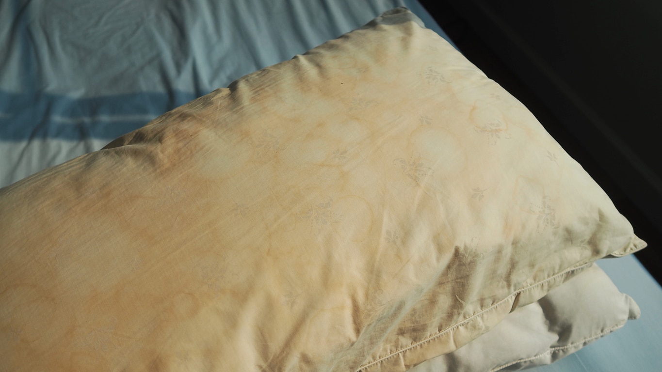 Why do pillows turn yellow. Heavily stained pillow