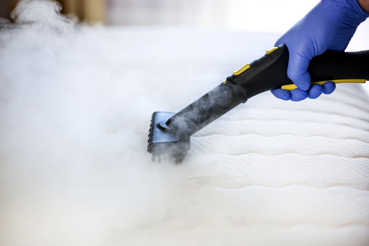 Can you steam clean a memory foam mattress? Close up of steam cleaner on mattress.